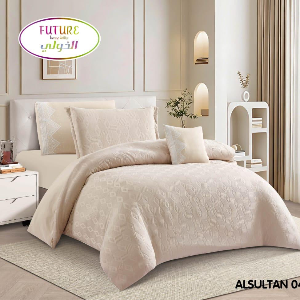 A beige 5-piece comforter set displayed on a bed in a styled bedroom scene, with a product inset showing the set packaging and details on the right. The brand logo 'FUTURE' with Arabic text and the product name 'ALSULTAN 04' are visible.
